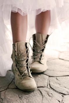 a close up of a person's legs wearing boots with laces on them