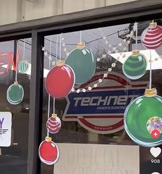 a storefront window with ornaments hanging from it's windows and an advertisement for technet