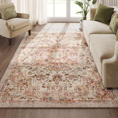 a living room area with couches, chairs and rugs