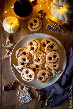 a plate full of cookies decorated to look like jack - o'- lanternes