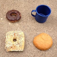 three different types of doughnuts and a cup of coffee on the ground next to each other