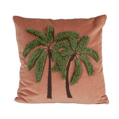 a brown pillow with two palm trees on the front and one green tree on the back