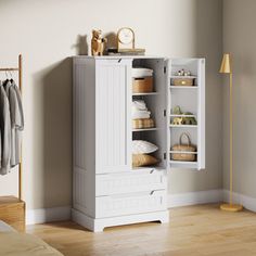 a white armoire in a bedroom next to a bed