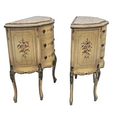 two antique chests with floral designs are shown side by side on white background, one has marble top and the other has gold trim