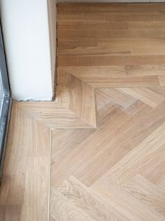 Installation of herringbone floors with brass inlay border - Toronto Victorian home renovation Tile Inlay Wood Floor Entryway, Brass Inlay Floor, Carriage House Kitchen, Victorian Home Renovation, Herringbone Floors, Inlay Flooring, Deco Tile, Toronto Home, Foyer Flooring