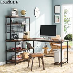 a computer desk sitting in front of a window with a clock on the wall behind it