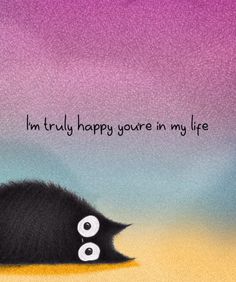 a black cat laying on top of a sandy beach next to the words i'm truly happy you're in my life