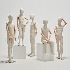 there are many mannequins standing on pedestals in the same position as each other