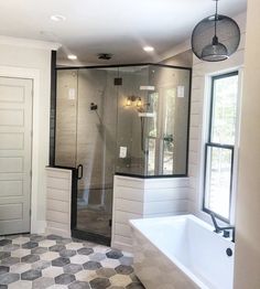 a large bathroom with a walk in shower next to a bathtub