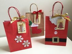 three small bags with christmas decorations on them