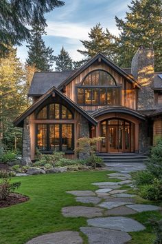 a large house with lots of windows and stone walkways leading to the front door