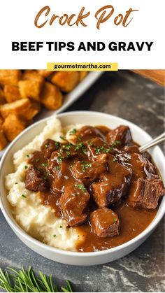 a bowl filled with beef and gravy on top of mashed potato wedges