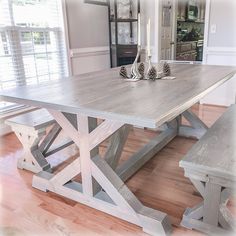 a dining room table with benches in front of it