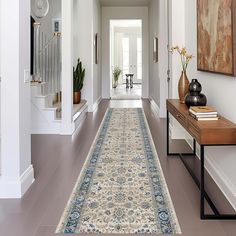 the hallway is clean and ready for guests to use it as an entrance way in this home