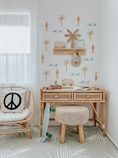 a room with two wicker chairs, a desk and a peace sign on the wall