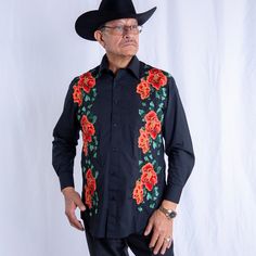 an old man wearing a black shirt with red roses on it and a cowboy hat