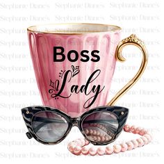 a pink coffee cup with sunglasses and pearls on the side that says boss lady next to it