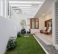 an outdoor living area with grass and rocks