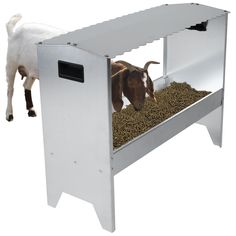 a goat is eating out of a food trough that's built into the side of a table