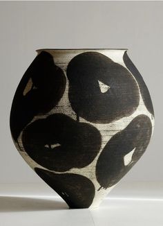 a black and white vase sitting on top of a table