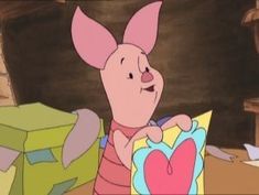 a cartoon pig holding a heart shaped box in front of other boxes and looking at it