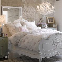 a white bed sitting in a bedroom next to a dresser