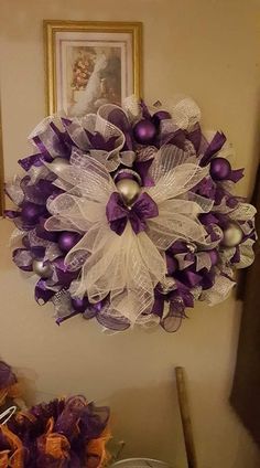 a purple and white wreath hanging on the wall