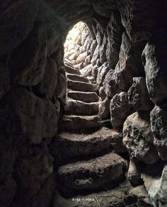 the light at the end of the tunnel shines brightly through the rocks and boulders