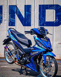 a blue motorcycle parked in front of a building