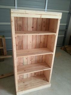 a wooden book shelf sitting inside of a garage