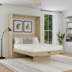 a bed sitting in the middle of a room next to a book shelf and window