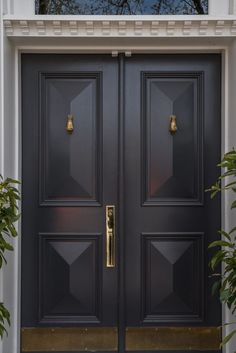 two black doors with gold handles and sidelights