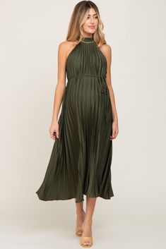 A stylish maternity dress perfect for cocktail parties and special occasions.  A solid maternity halter dress in a shimmery pleated material with a sash tie waist and keyhole button closure in back. The Olive Pleated Maternity Halter Dress is perfectly bump-friendly! Forest Green Maternity Dress, Maternity Dresses Green, Fall Wedding Guest Dress Pregnant, Bump Friendly Cocktail Dress, Cocktail Dress Pregnant, Cocktail Maternity Dress, Maternity Cocktail Attire, Maternity Black Tie Dress, Olive Green Wedding Guest Dress