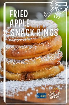 a stack of fried apple rings with powdered sugar on top