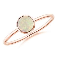 Simple yet elegant, this classic solitaire opal ring is sure to fascinate. The cabochon opal, secured in a bezel setting, allures with its delightful color play. This 14k rose gold round opal ring has a sleek shank that adds to its effortless beauty. Minimalist Round Cabochon Opal Ring, Formal Rose Gold Opal Ring, Classic Rose Gold Opal Ring, Classic Opal Birthstone Ring With Round Band, Elegant Opal Ring With Bezel Setting, Minimalist Opal Ring With Bezel Setting, Cabochon Opal Round Rings, Opal Cabochon Round Rings, Fine Jewelry Opal Solitaire Ring