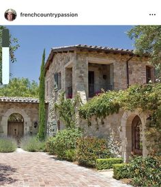 an image of a stone house with plants growing on the front and side walls, in french country passion