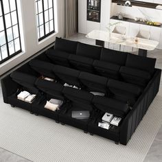 a living room filled with lots of black furniture