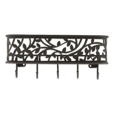 wrought iron wall mounted coat rack with four hooks and an ornate design on the top