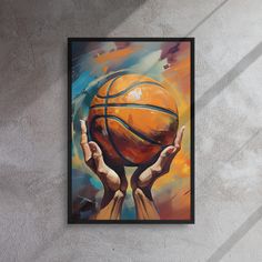 two hands holding a basketball in front of a painting on the wall, with one hand reaching for it