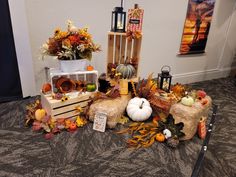 an arrangement of fall decorations on the floor