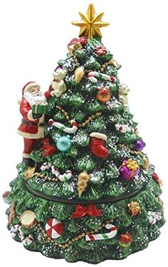 a small christmas tree with santa claus and other ornaments on it's top,