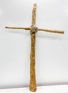 a cross made out of wood and rope