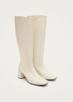 White vegan knee-high boots with heels Chalk is a vegan boot crafted from faux leather with a polished white finish. Coming in a knee-high, it features a chunky block heel and slim, squared toes. Plus, full-length zippers on the side ensure they slip on and off with ease. White Knee High Boots, Boots With Heels, White Leather Boots, Vegan Leather Boots, Vegan Boots, Chunky Block Heels, White Boots, Brunei, Laos