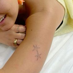 a woman with a star tattoo on her arm