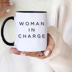 a woman in charge coffee mug on her hands