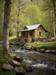 a small cabin sits next to a stream in the woods