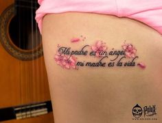 the back of a woman's stomach with pink flowers and an inscription on it