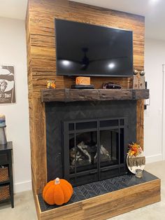 a fireplace with a flat screen tv mounted on it's wall above the fire place