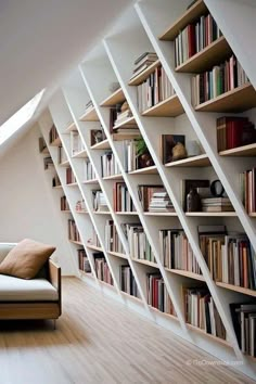 a couch sitting in front of a book shelf filled with books