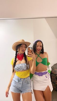 two women are taking a selfie in front of a mirror while wearing cowboy hats